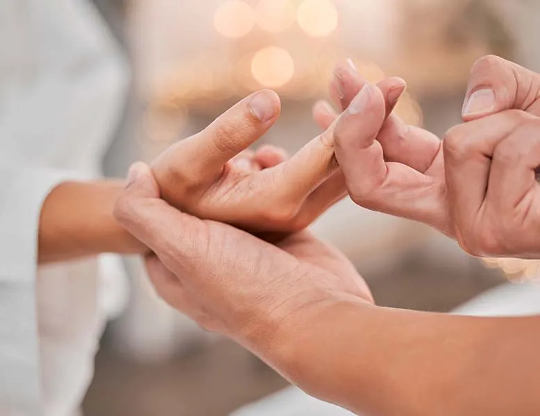 Senior woman holding her hand showing arthritis pain in the knuckles