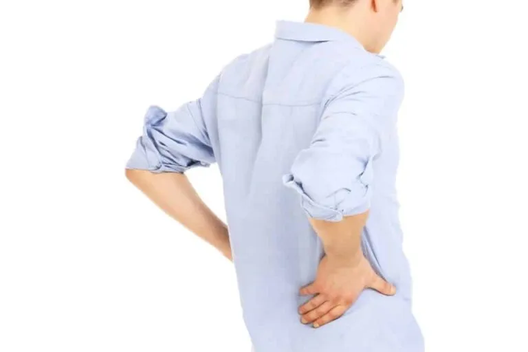 Man holding his lower back, showing chronic back pain
