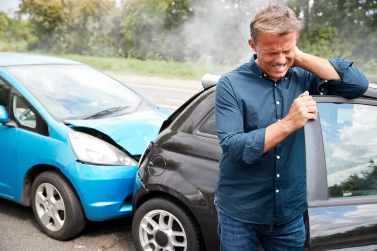 Patient with a whiplash collar receiving care after a motor vehicle accident